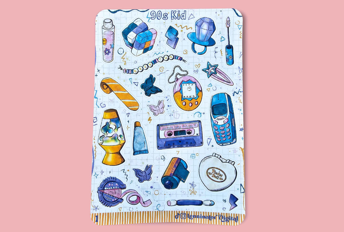 A sticker sheet featuring a colorful 90s kid-themed pattern with retro gadgets and toys, finished with a gold and white striped fringe, displayed flat against a solid pink background.