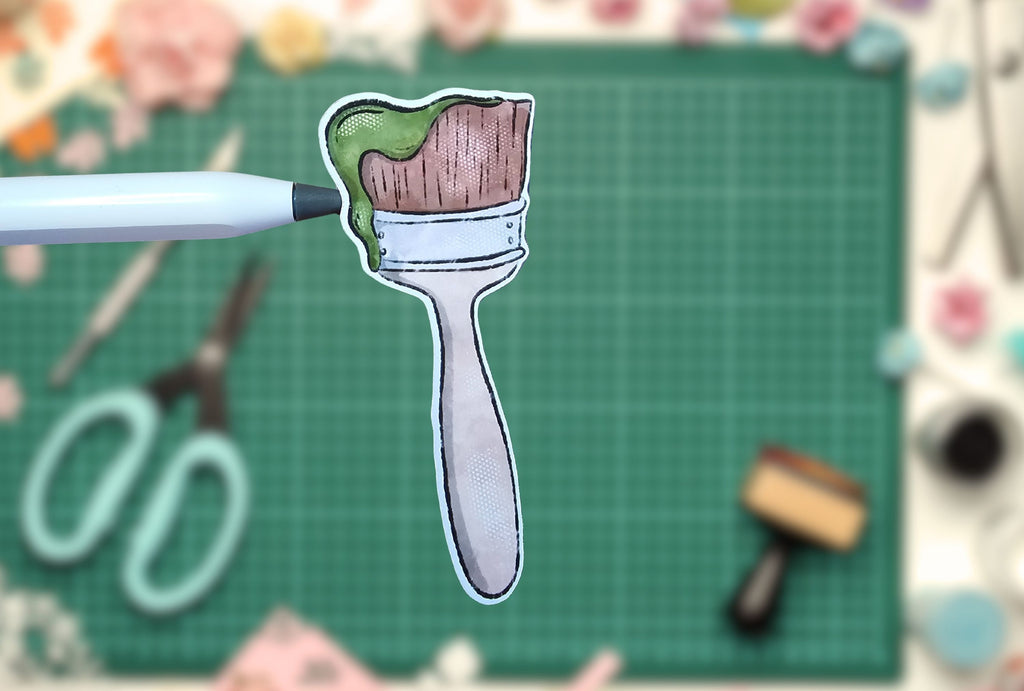 Illustration of a paintbrush with a wooden handle on a green cutting mat.