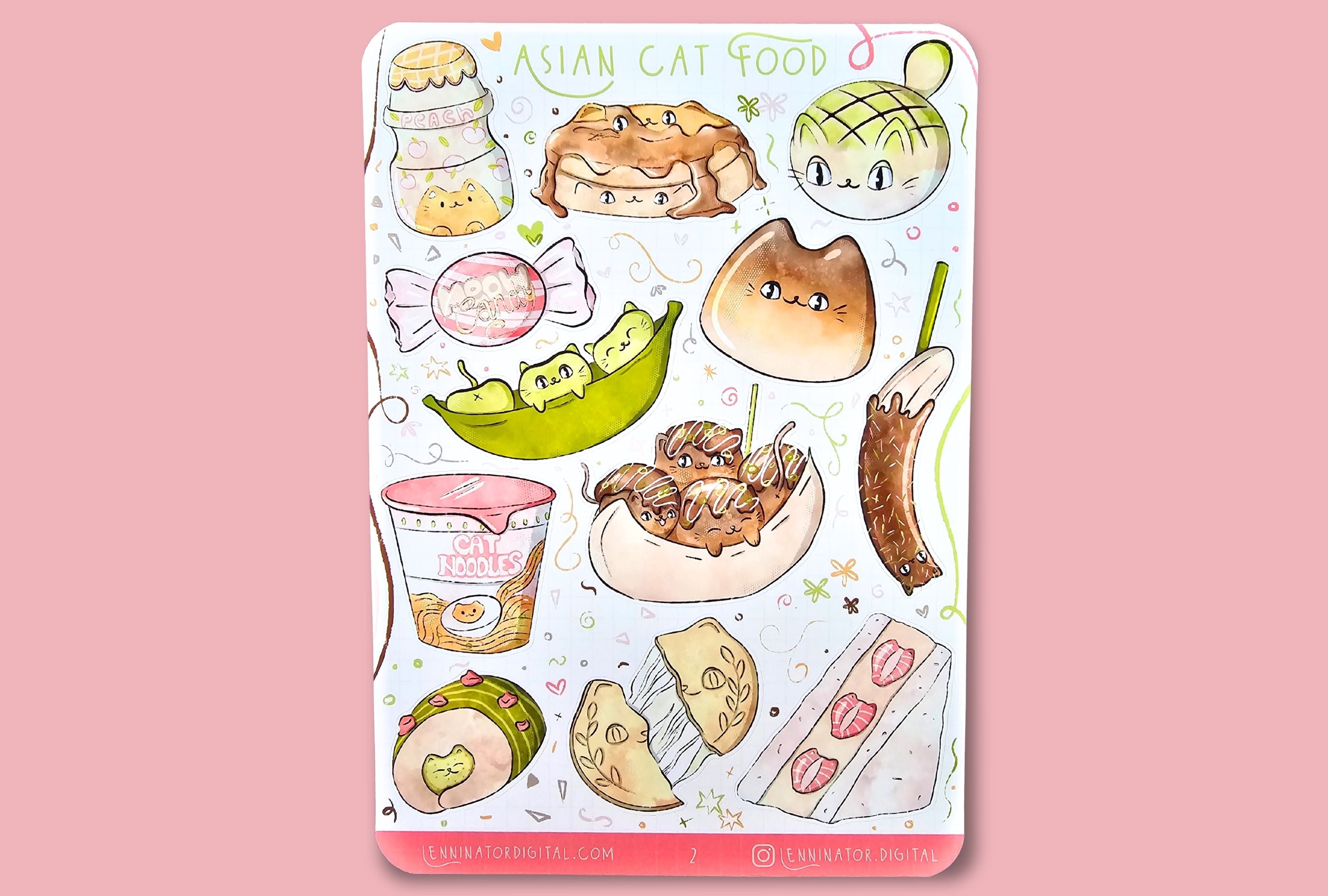 Sheet of cat-themed stickers on a wooden surface with a red and white patterned cloth.