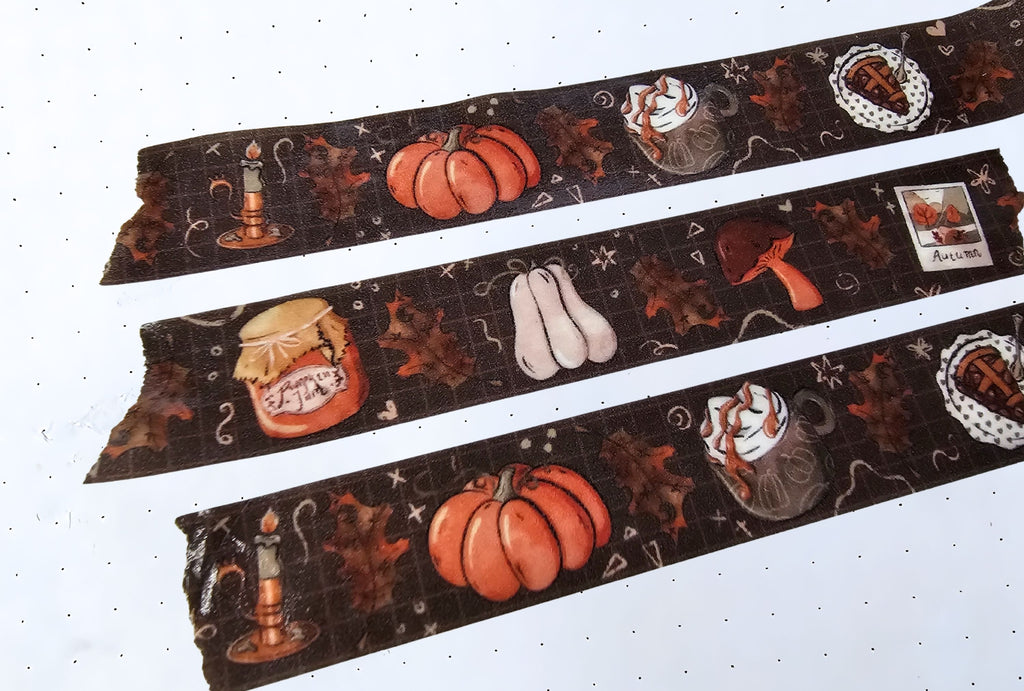 Close-up of a fall themed washi tape with pumpkins, leaves, mushroom, candles and pie