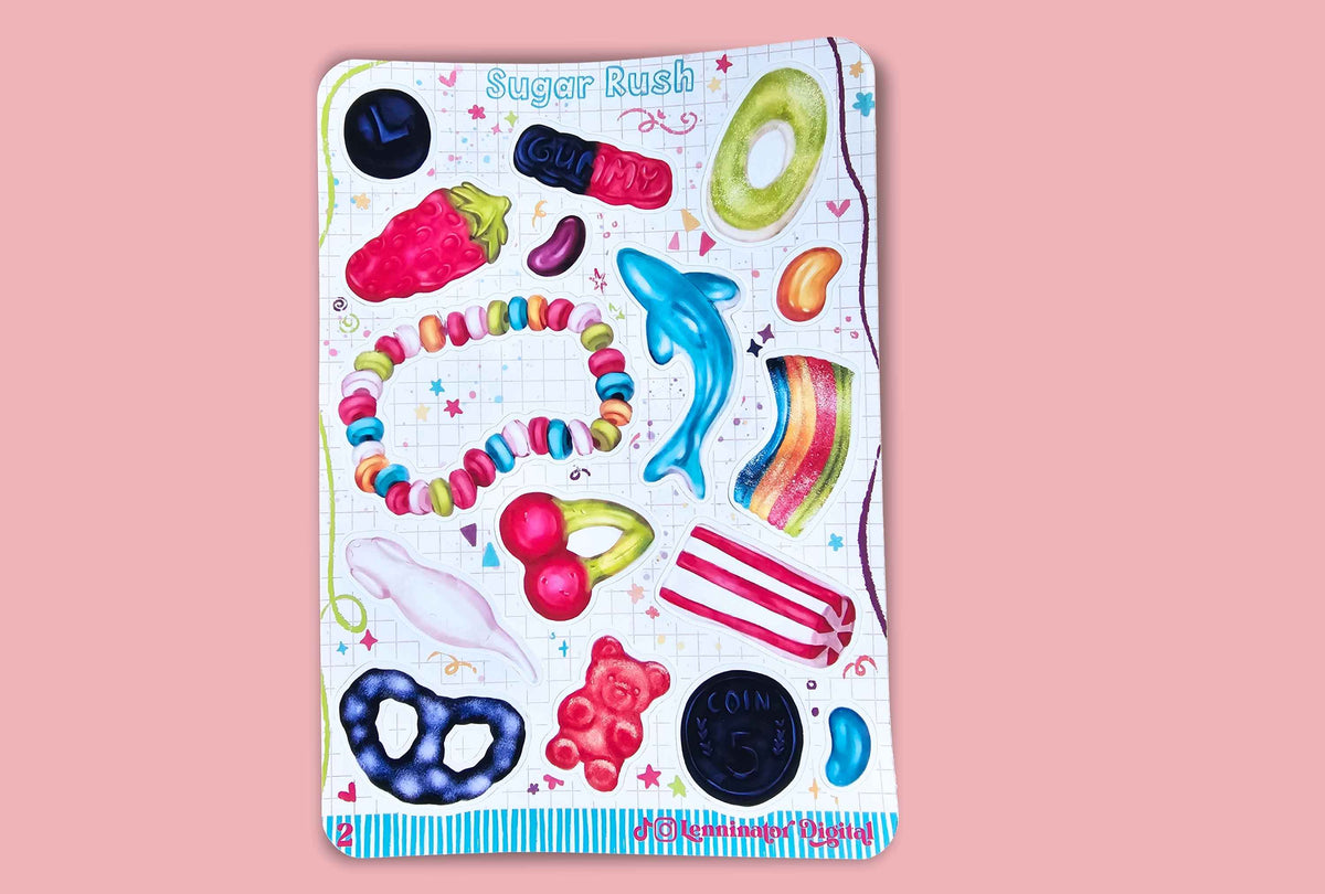 A rectangular sticker sheet titled 'Sugar Rush' featuring colorful watercolor illustrations of candy and sweets, including a blue dolphin, rainbow gummy, pretzel, gummy bear, and jelly beans, displayed against a solid pink background.