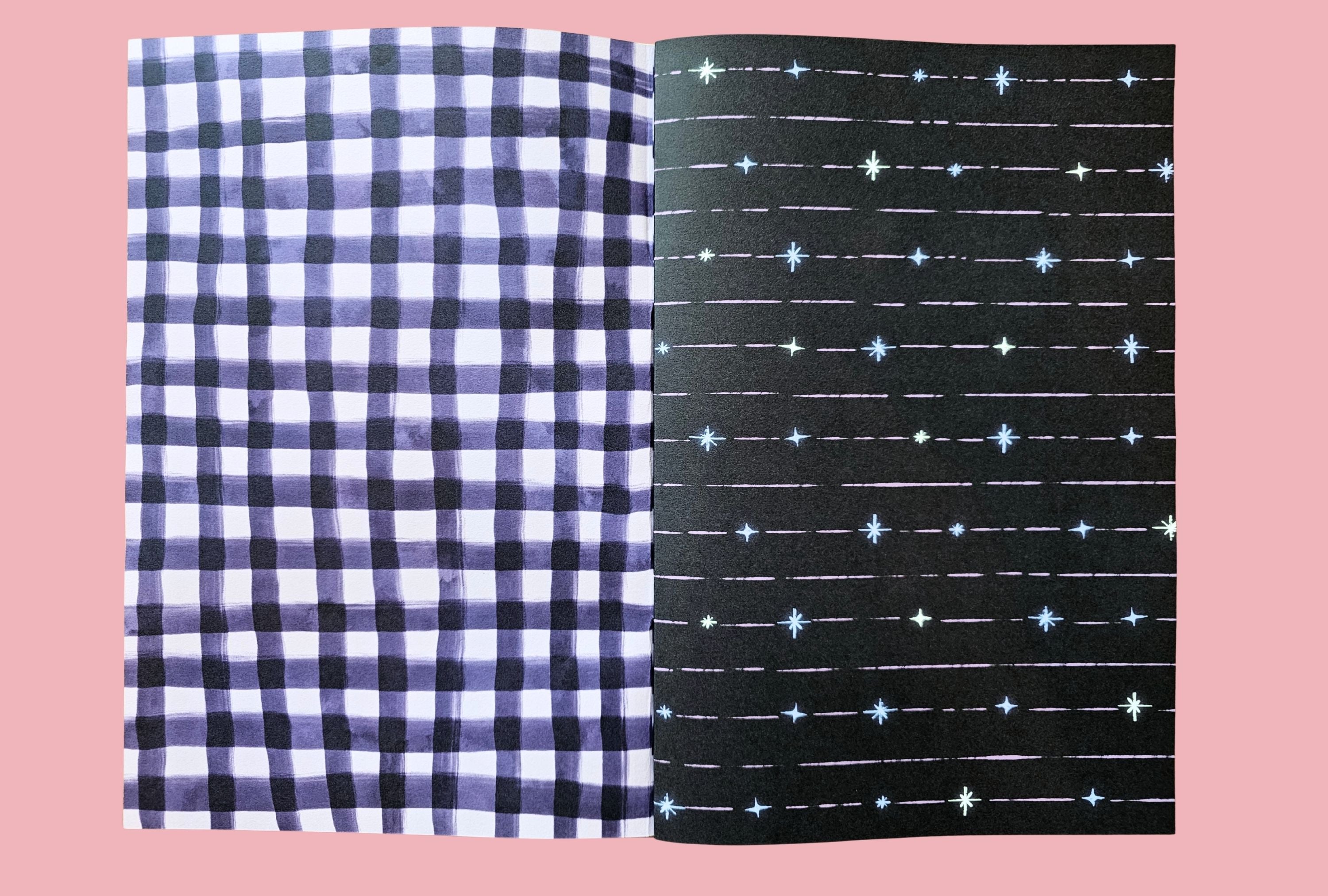 Two journal papers, one checkered gingham and one with star pattern, on a pink background