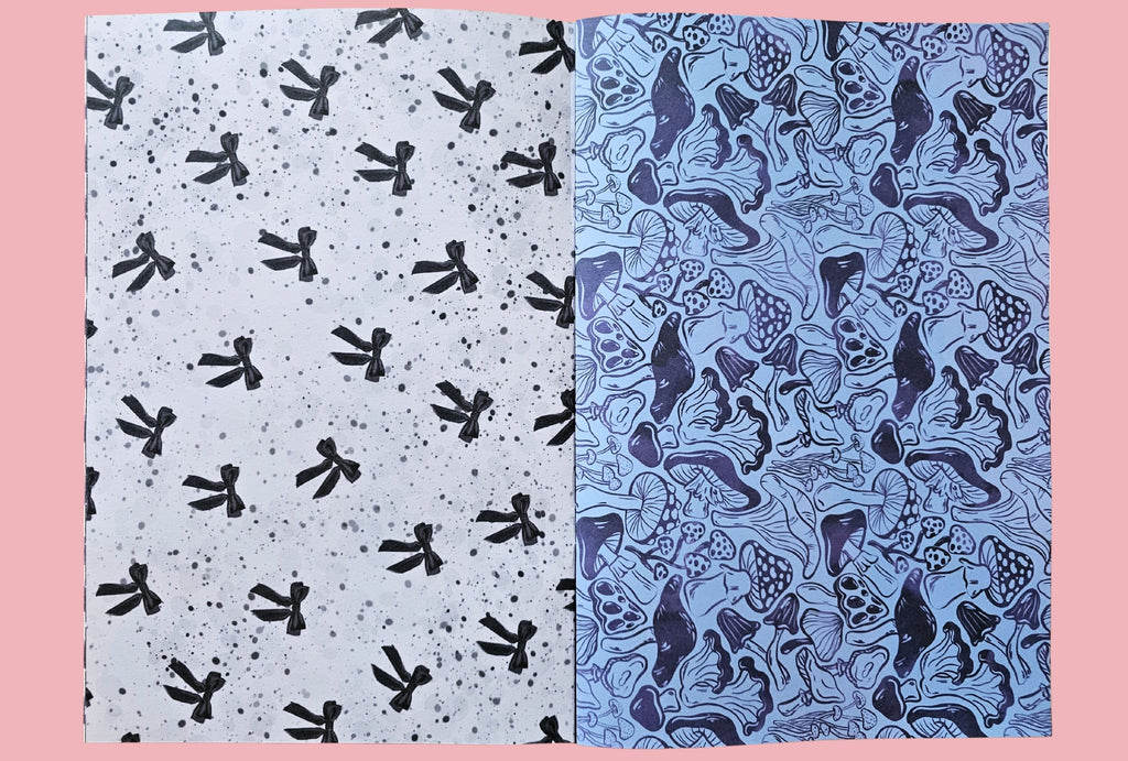 Two patterned papers with black ribbons and blue mushrooms on a pink background