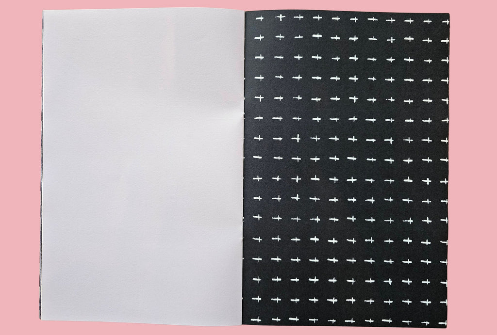 Black paper with white cross pattern on a pink background