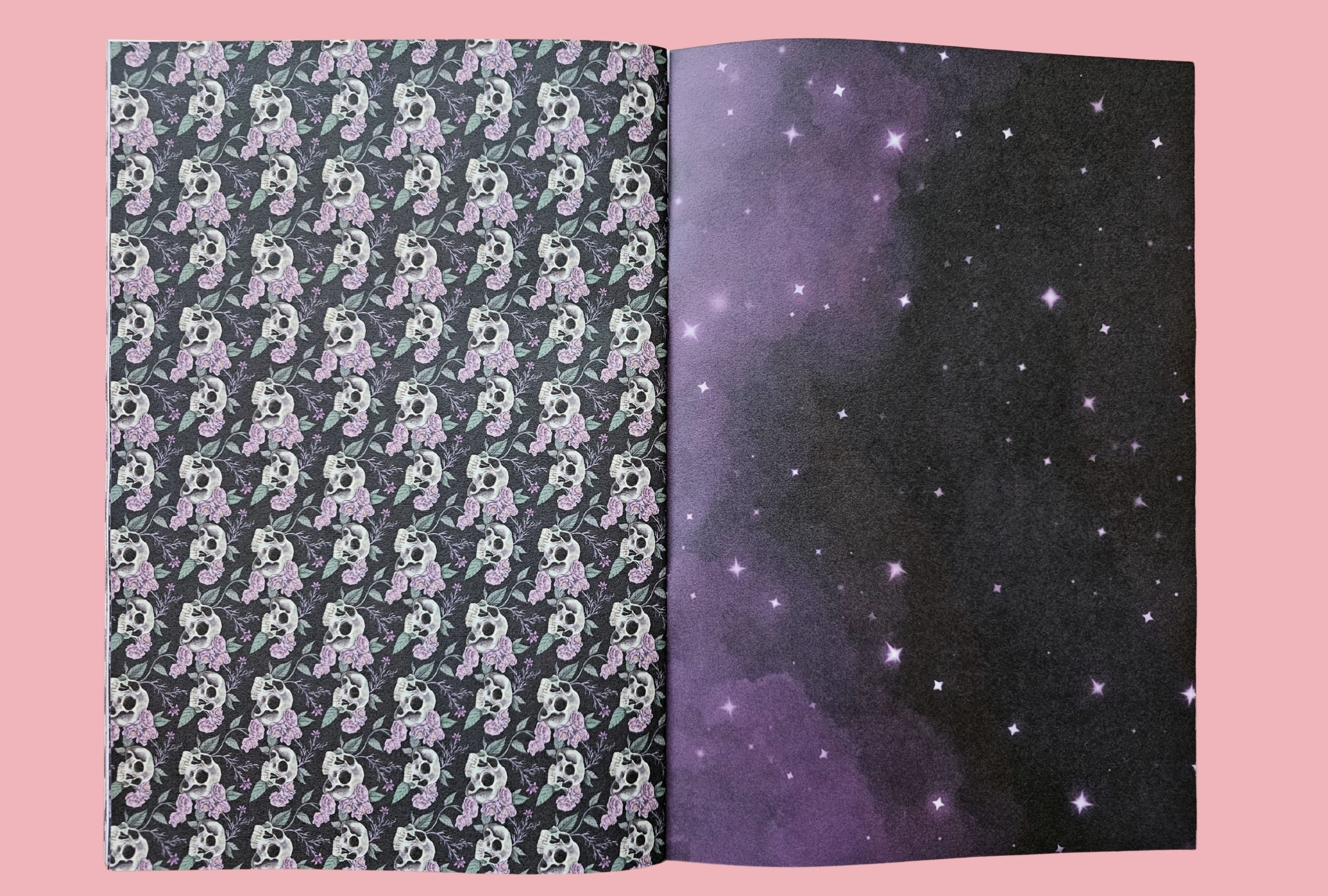 Two pages of a book showing a skull pattern on one side and a starry night sky on the other, against a pink background.
