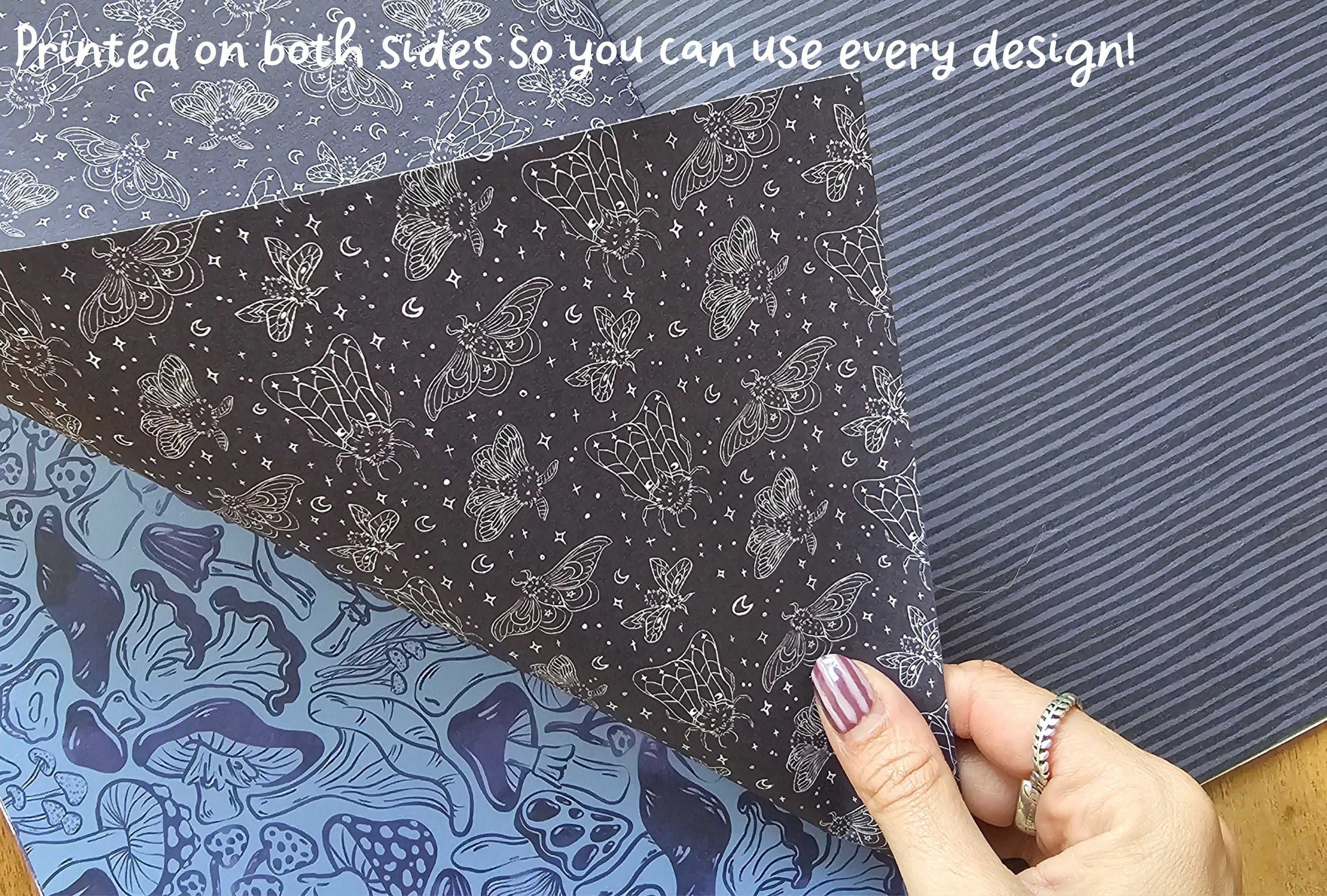 Black paper with white butterfly pattern held over blue paper with mushroom pattern, text 'Printed on both sides so you can use every design!' above.