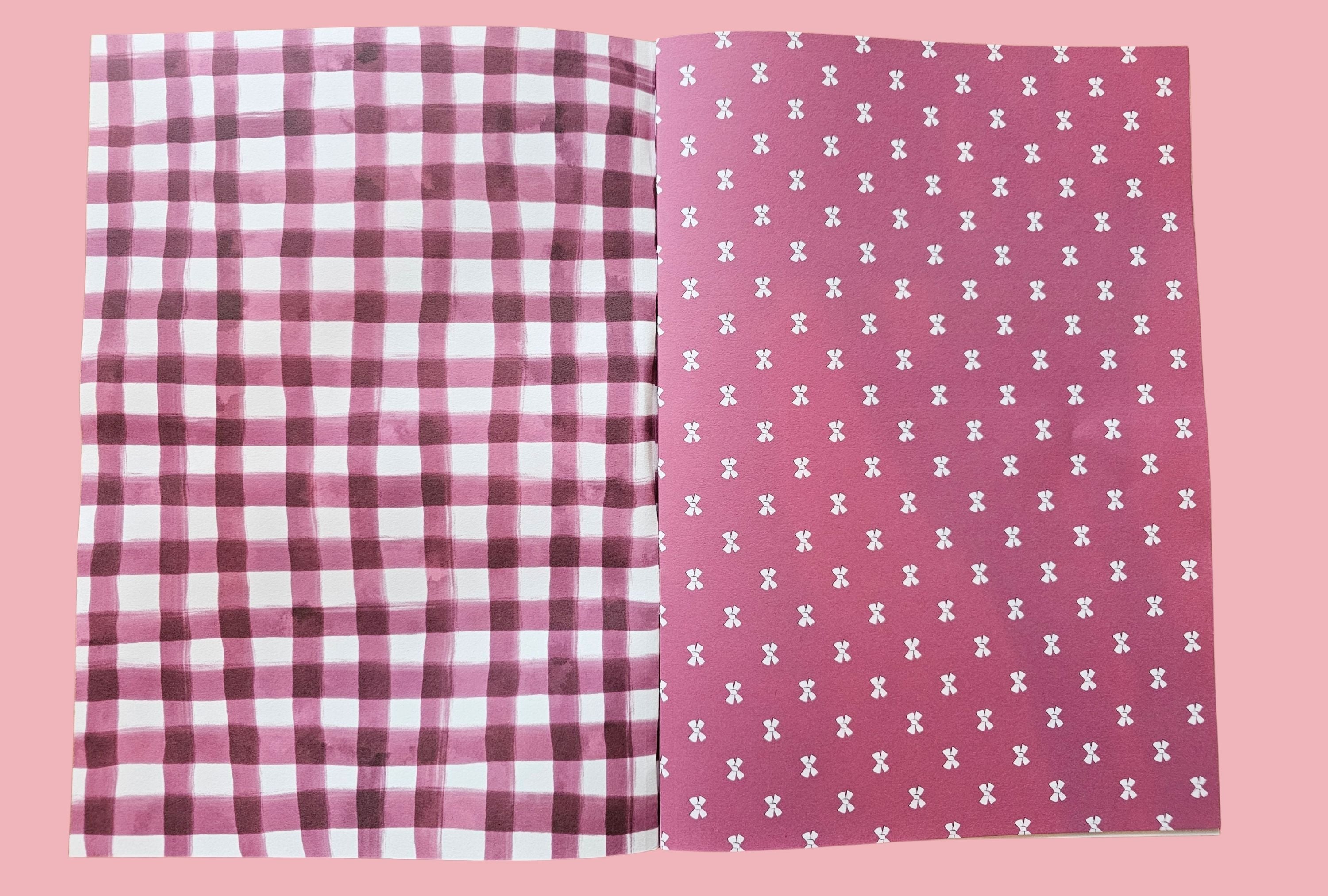 Two paper pages with checkered gingham and ribbon patterned designs on a pink background