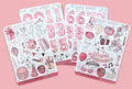 Set of pink birthday-themed sticker sheets on a pink background