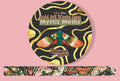 A roll of decorative washi tape labeled 'Mystic Moths' on a pink background, with the circular package showing a large moth illustration and a strip of the patterned tape displayed below.