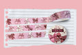A roll of pink washi tape decorated with cute ribbons