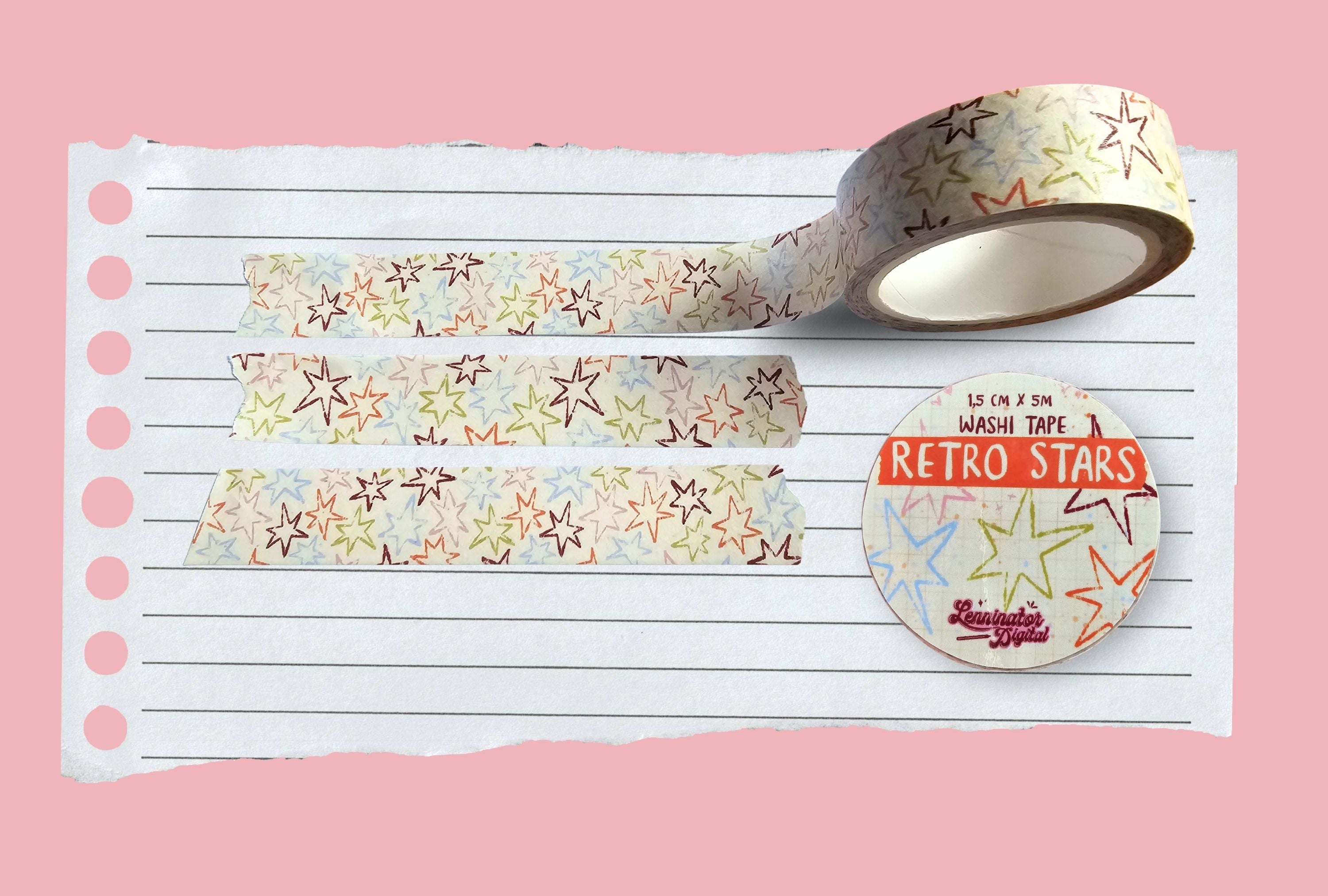 Roll of retro star-patterned washi tape on a pink background