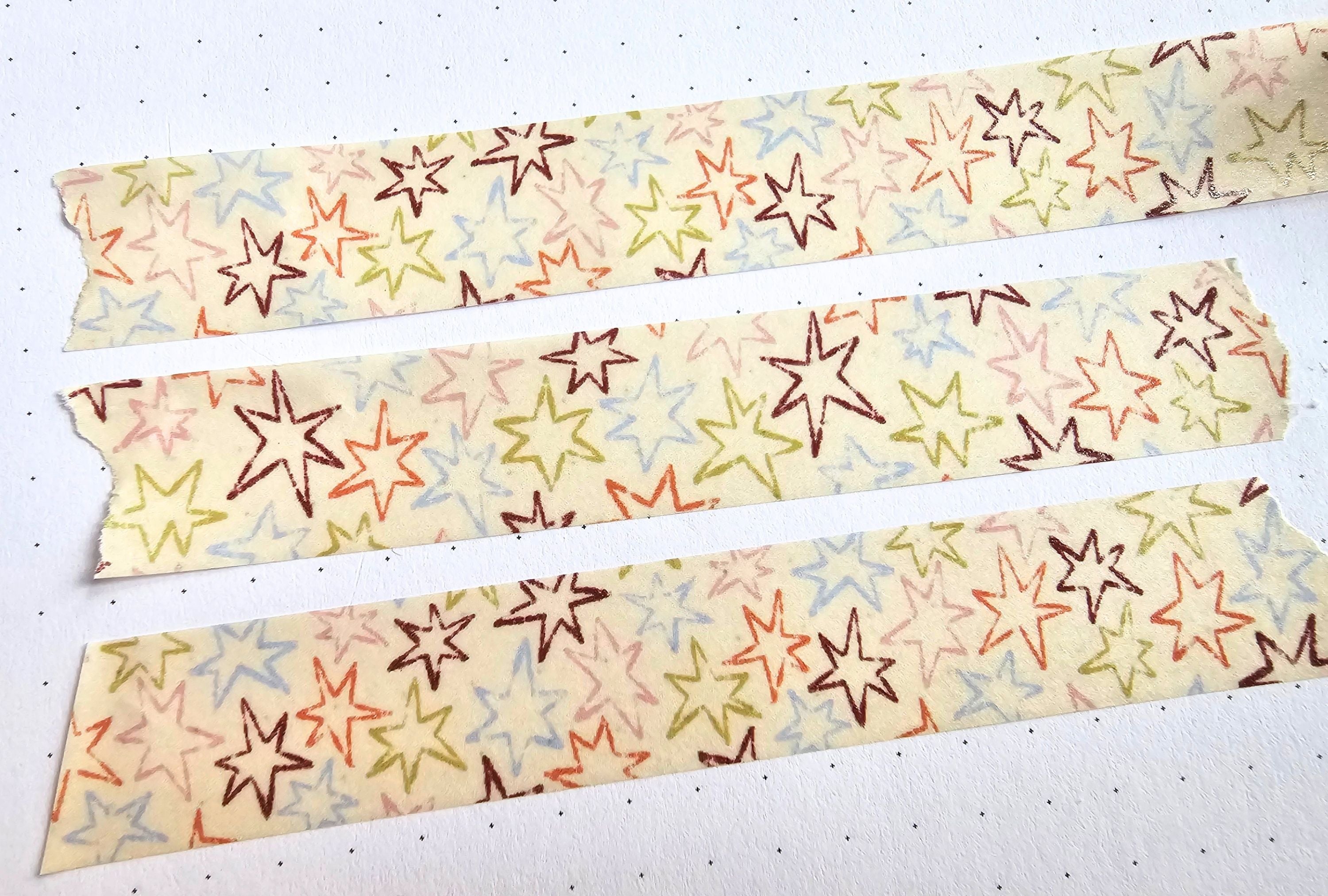Three strips of washi tape with star pattern on a white background