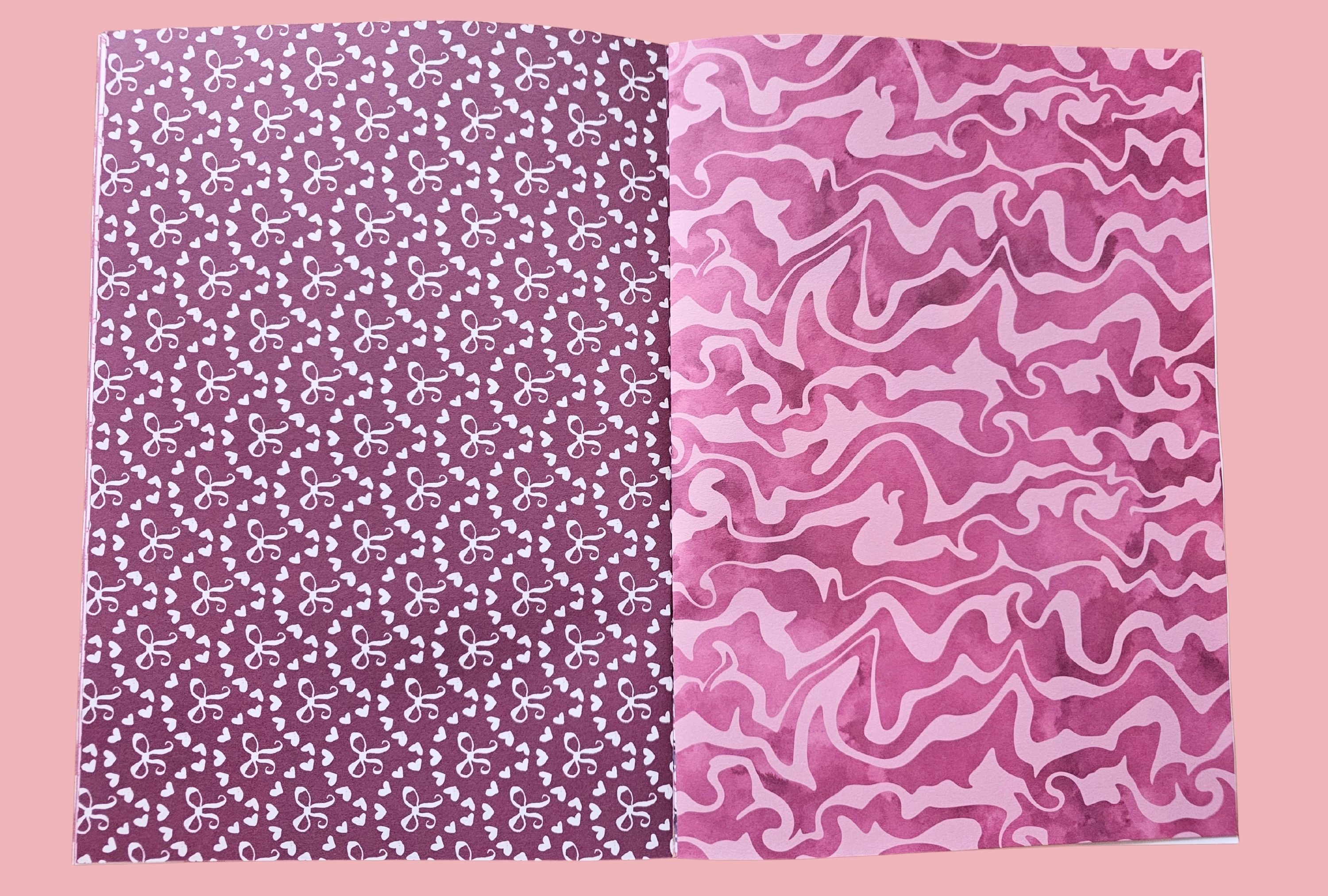 Two pieces of papers with different patterns on a pink background