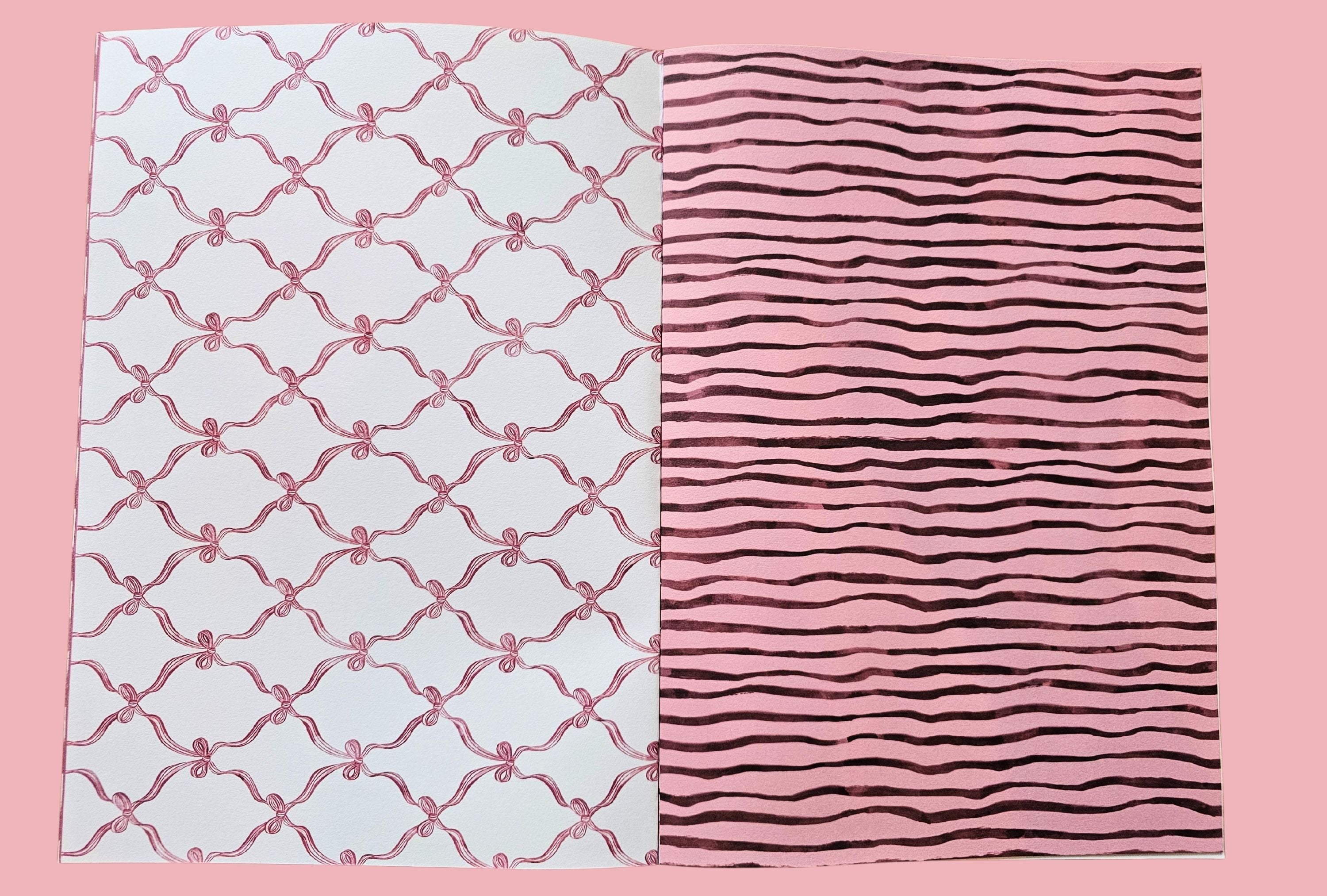 Two journal papers with different patterns on a pink background