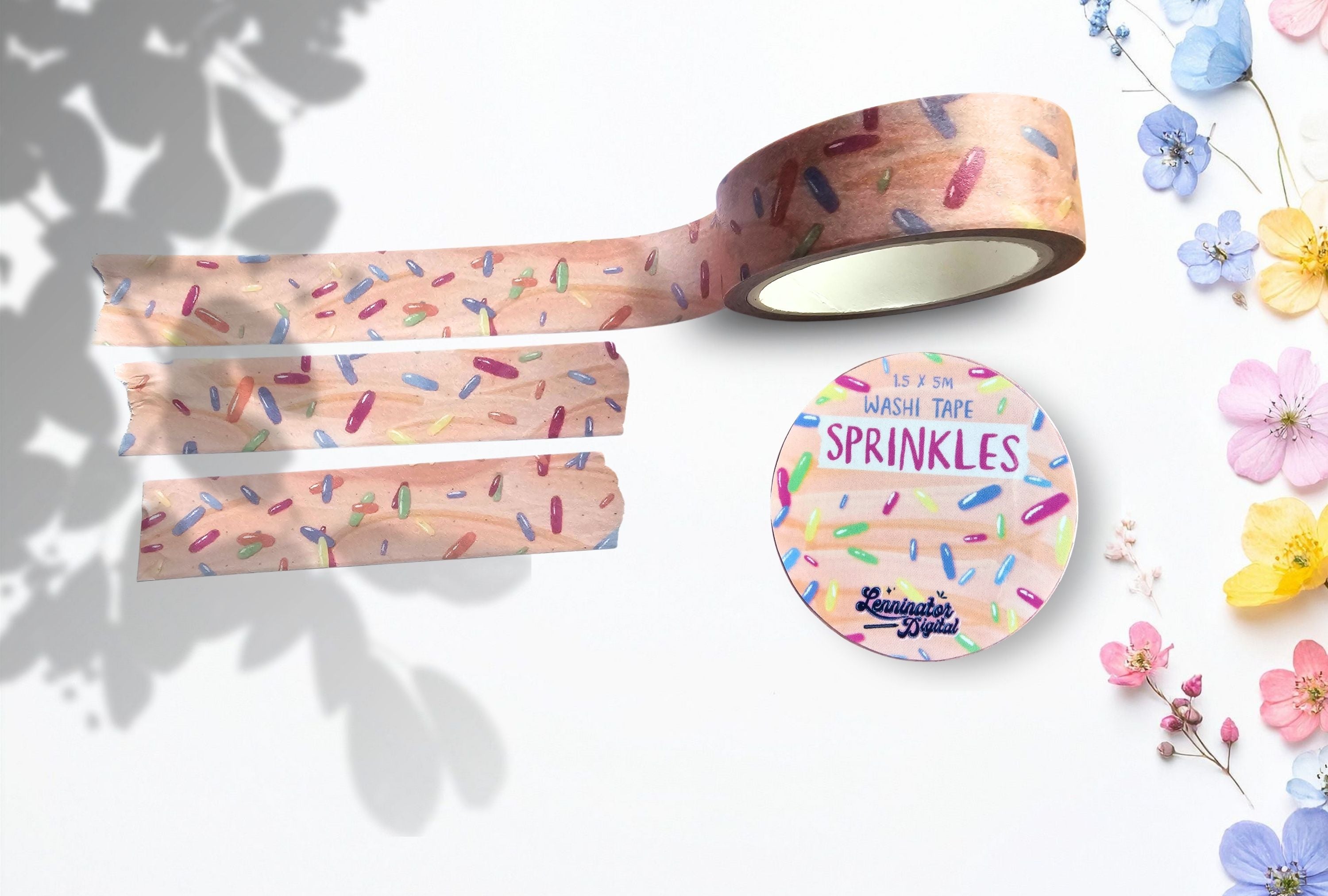 Decorative washi tape with sprinkles design on a white background with flowers.