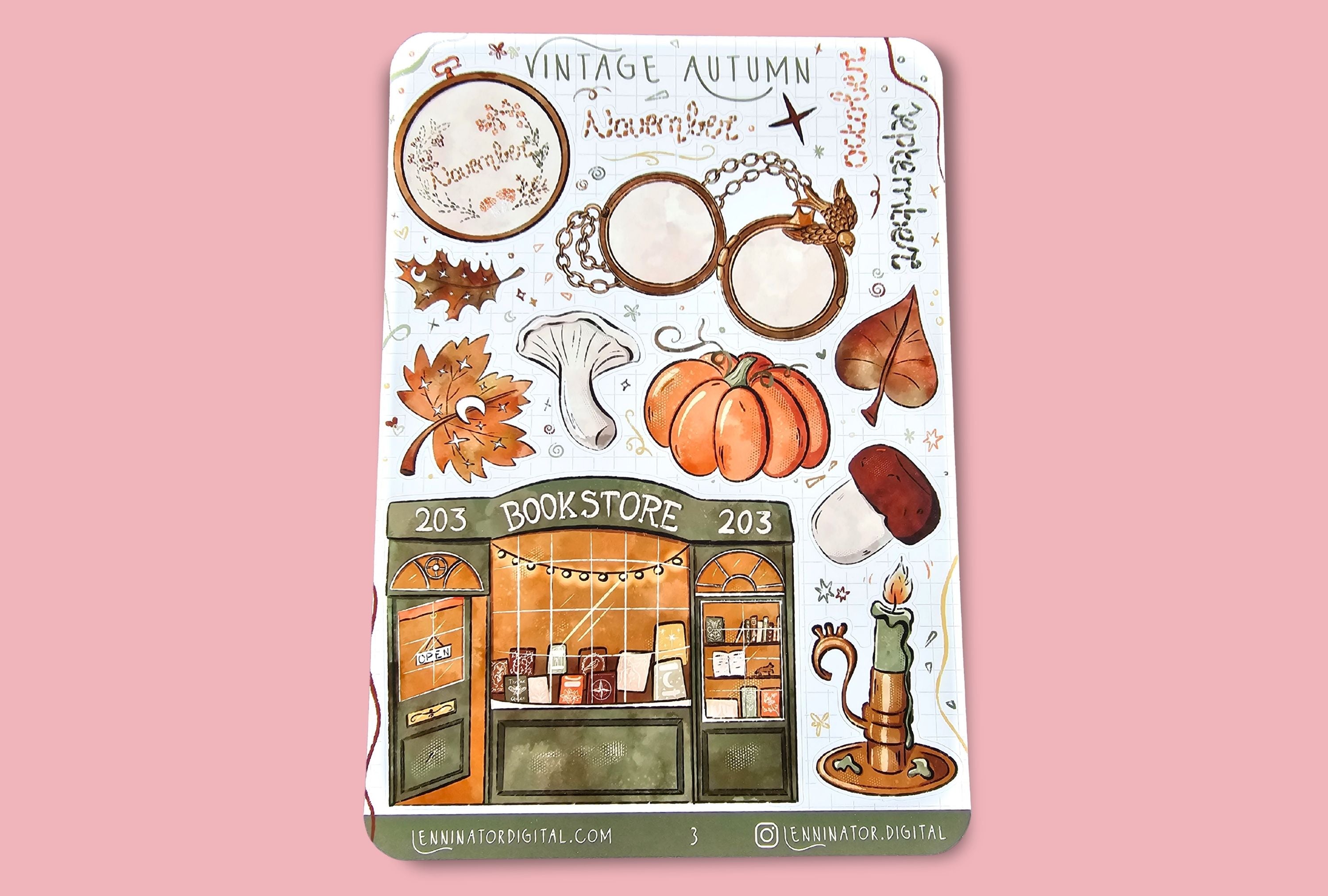 Sticker sheet with autumn-themed designs on a white surface with wheat stalks.