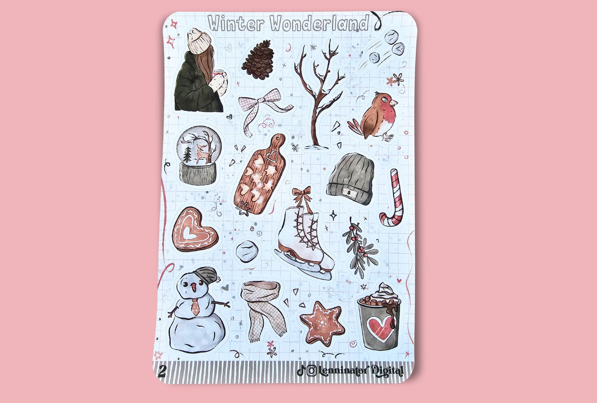 A rectangular sticker sheet titled 'Winter Wonderland' featuring various hand-drawn winter illustrations like a snowman, snow globe, ice skates, candy cane, pine cone, and winter clothing on a pale blue background, set against a solid pink backdrop.