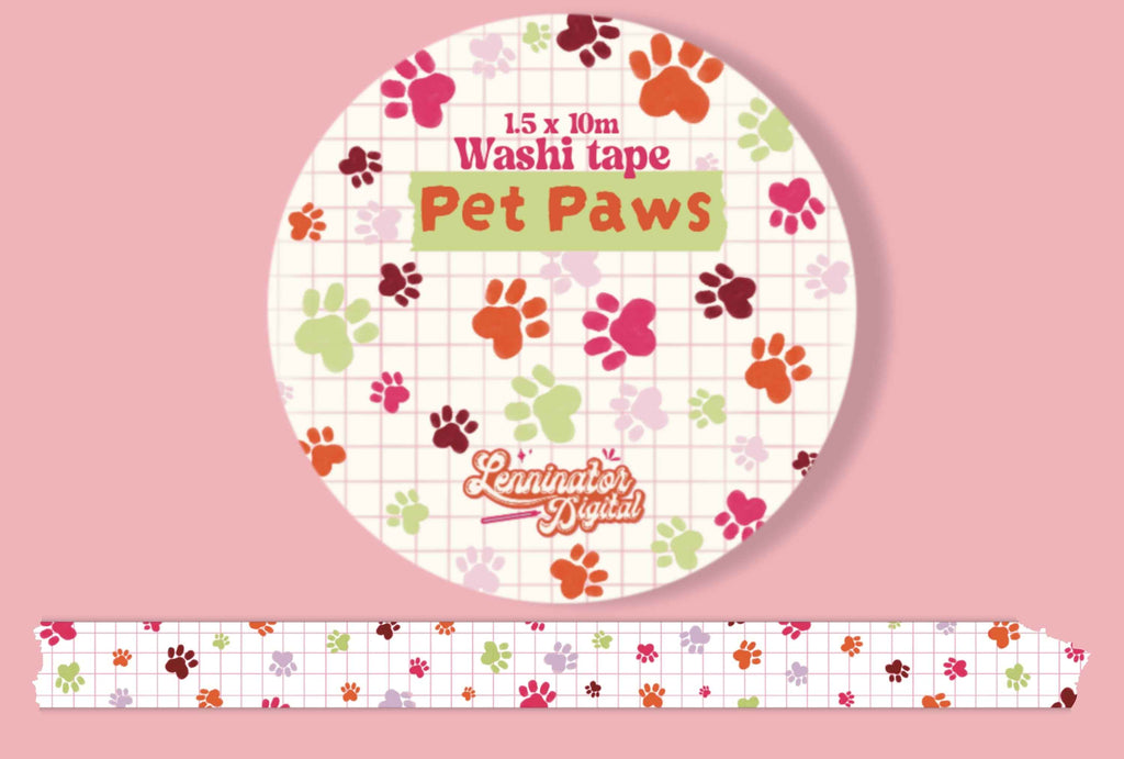 A roll of decorative washi tape labeled 'Pet Paws' with a pink and white grid background and scattered paw print motifs in multiple colors, shown on a pink backdrop with a strip of the tape unrolled below.